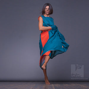 Experimental  turquoise and orange dress with big side pockets and geometrical pattern. 